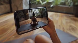 person-is-holding-smartphone-their-hand-phone-is-showing-video-woman-doing-yoga